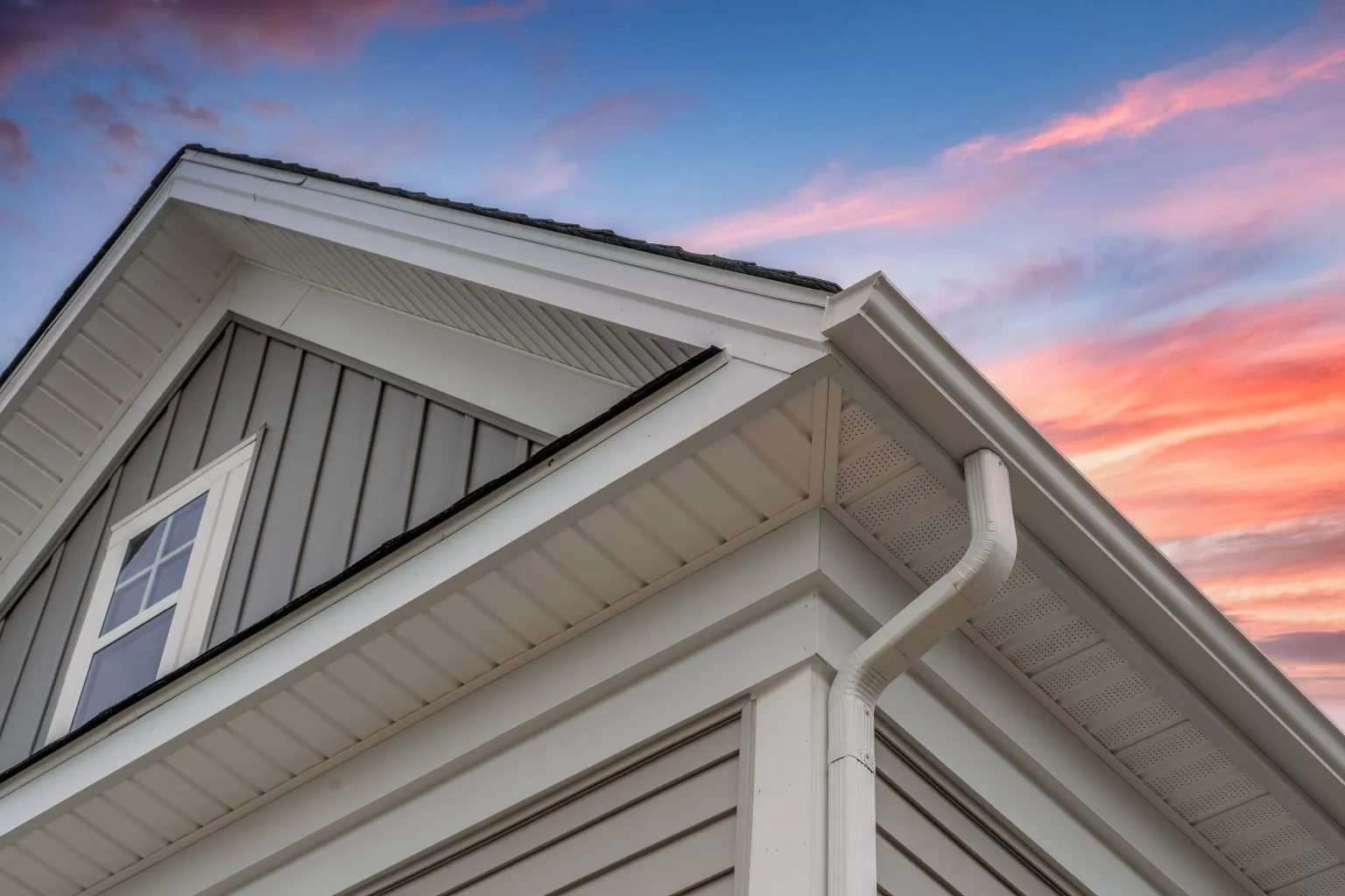 Modern home with clean white gutters at sunset