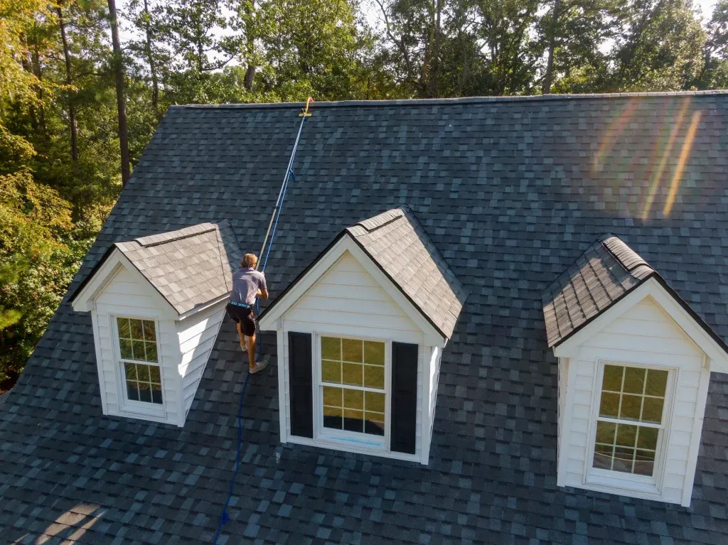 Gray house with white trim and asphalt shingle roof